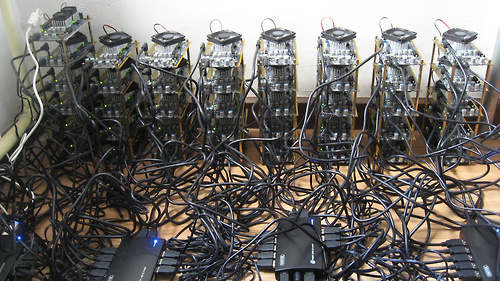 The World&#8217;s Most Powerful Computer Network Is Being Wasted on Bitcoin, via algopopBecause of the way Bitcoin self-regulates, the math problems Bitcoin mining rigs have to do to get more &#8216;coin get harder and harder as time goes on. Not to any particular end, but just to make sure the world doesn&#8217;t get flooded with Bitcoins. So all these computers aren&#8217;t really accomplishing anything other than solving super difficult and necessarily arbitrary puzzles for cyber money. It&#8217;s kind of like rounding up the world&#8217;s greatest minds and making them do Sudokus for nickels.Projects like Folding@Home and SETI@Home use similarly networked power for the less-pointless practices of parsing information that could lead to more effective medicines or finding extra-terrestrial life, respectively, and either are hard-pressed to scrounge up even half of a percent of the power the Bitcoin network is rocking. And with specialized Bitcoin-mining hardware on the rise, there&#8217;s going to be an army of totally powerhouse PCs out there that are good for literally nothing but digging up cybercoins.It&#8217;s incredible to think about the amount of power being directed at this one, singular purpose; power that&#8217;s essentially being &#8220;donated&#8221; by thousands of people across the globe just because they have skin in the game. It&#8217;s by far the most computational effort that has ever been devoted to a single purpose. And sure, Bitcoins are fine and all, but can you imagine what we could do if this energy was put behind other tough problems? We&#8217;ll you&#8217;re going to have to imagine, because so long as mining Bitcoins can earn you money and folding proteins can&#8217;t, it&#8217;s pretty clear which one is gonna get done.